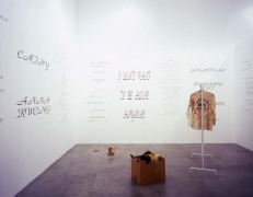 Mike Kelley, Written in the Wind, 1991 (Detail). Cardboard box, 10 found stuffed animals, coat rack with jacket &amp;amp; shirt, ten wall texts, dimensions variable. MP 9180